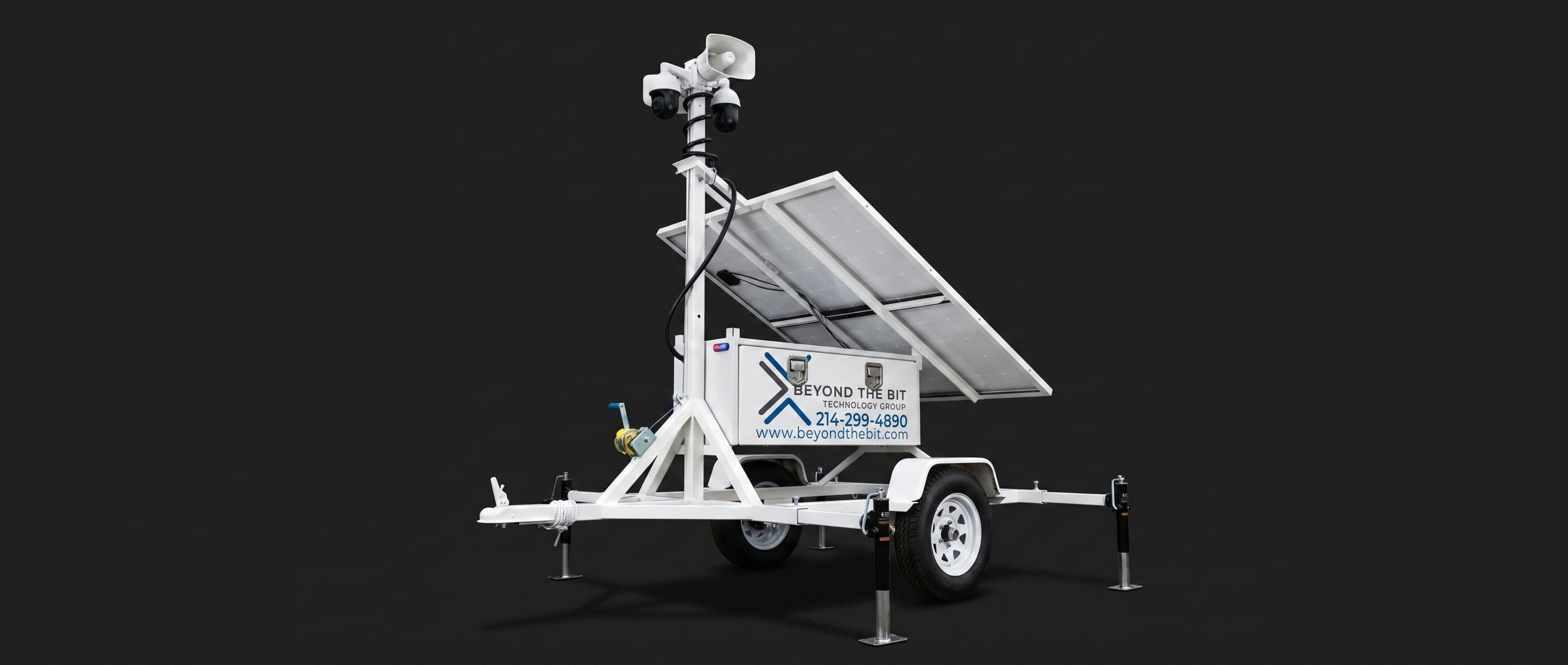A Beyond the Bit security trailer studio product shot on a dark background, camera mast raised.