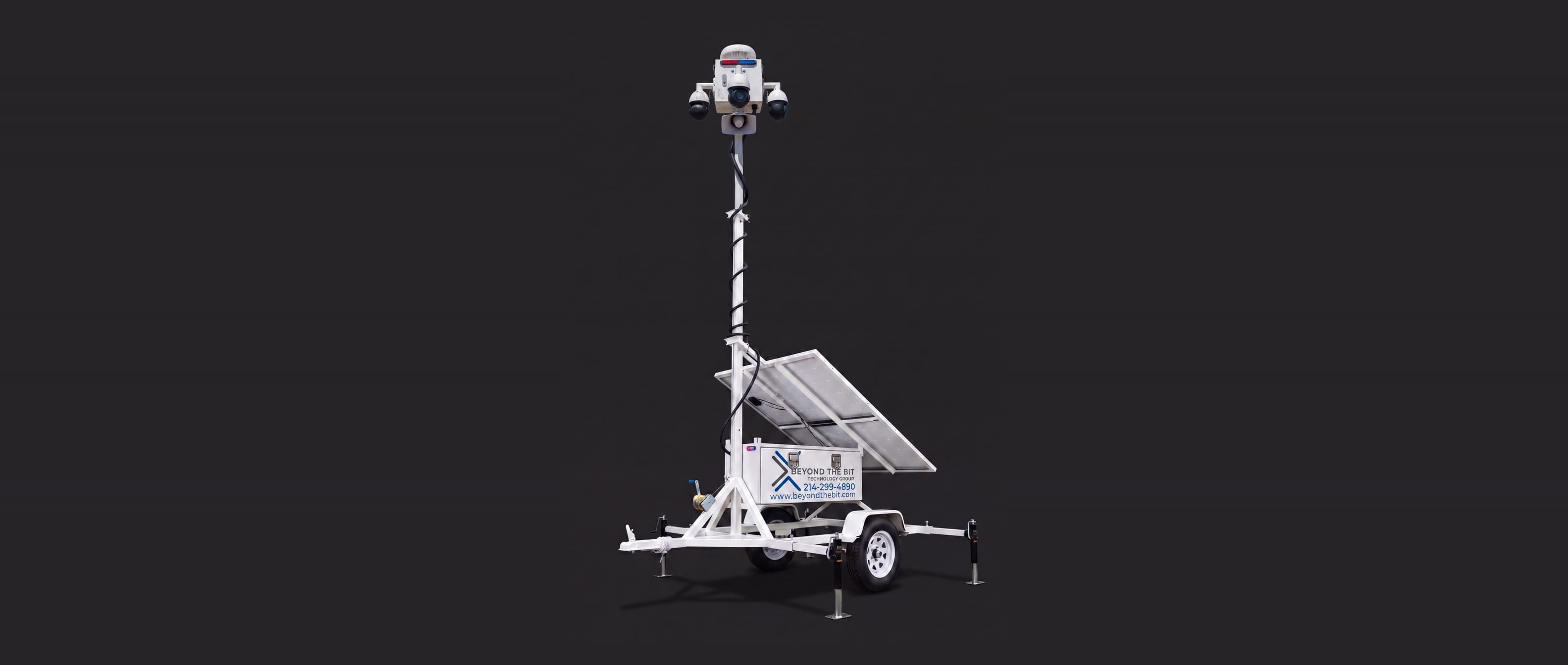 A Beyond the Bit security trailer studio product shot on a dark background, camera mast raised.